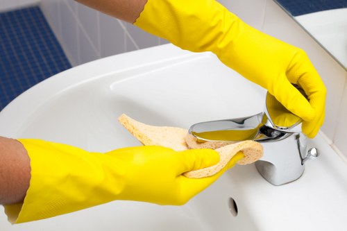 Professional cleaner tidying a kitchen in the N19 area